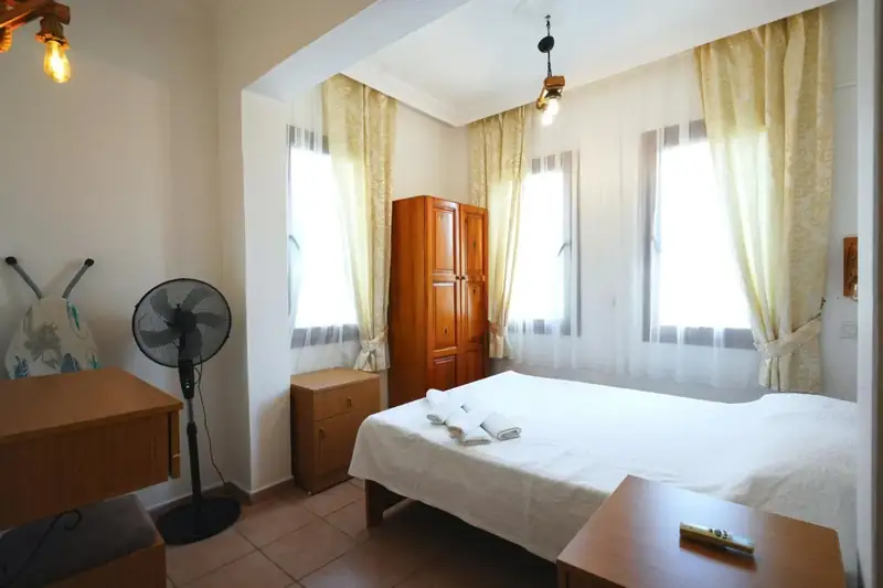 A spacious room with a desk and wardrobe