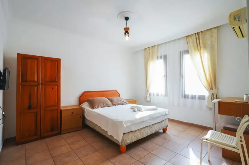 Double bed, wardrobe and windows